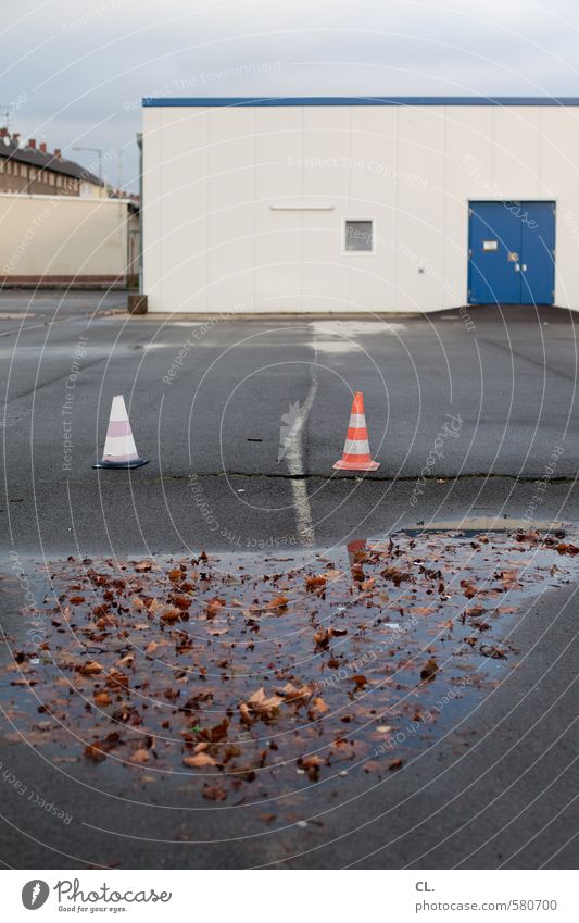 ut pascha | parking, puddles + pylons Sky Autumn Bad weather Rain Leaf Industrial plant Factory Places Building Door Wet Gloomy Stagnating Puddle Traffic cone