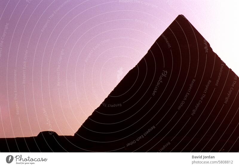 Pyramid in front of a pink violet sky Pink purple Violet vacation Relaxation rest visit places of interest Curious about other cultures Impressive Landscape