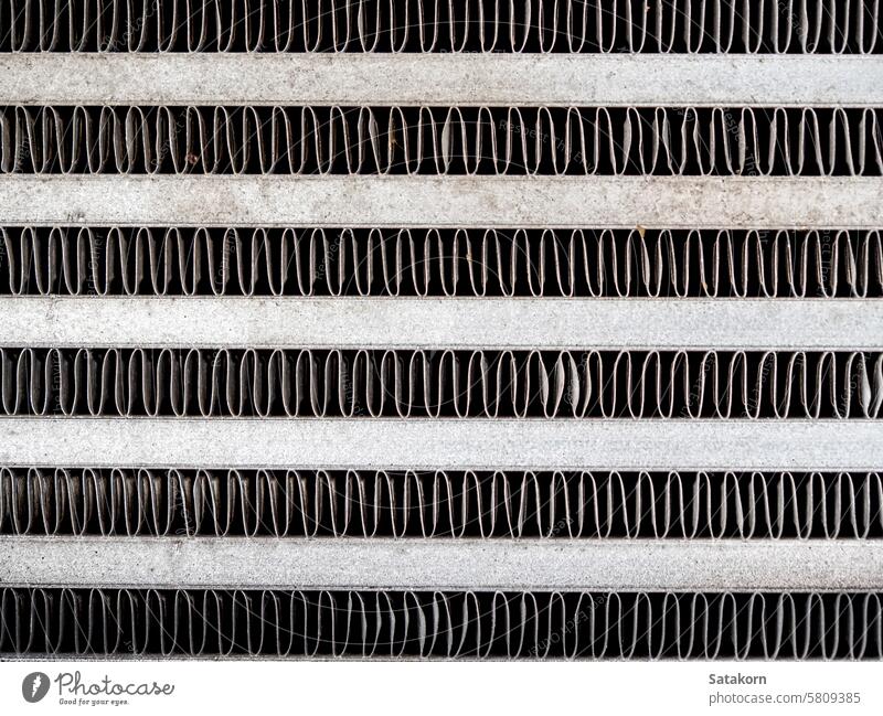 The metal grill of a car radiator is old and has scale marks texture cooling part vehicle grunge detail automotive white engine background equipment