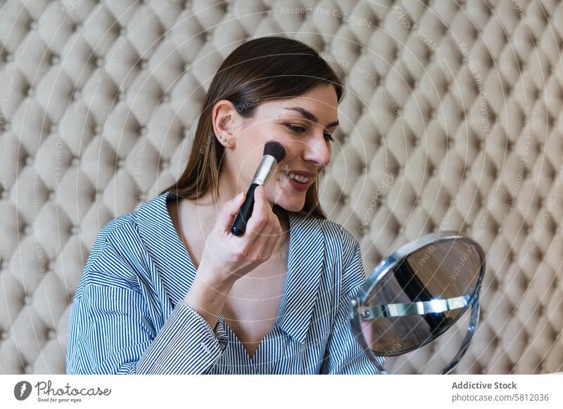 Happy woman applying powder and recording video on camera makeup blogger brush toothy smile visage cheerful influencer attractive happy cosmetic brunette