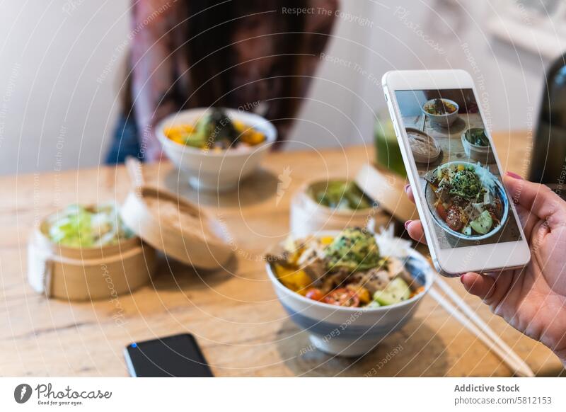 Anonymous woman taking photo of dish in restaurant women take photo food photography social media smartphone friend together female gadget device weekend