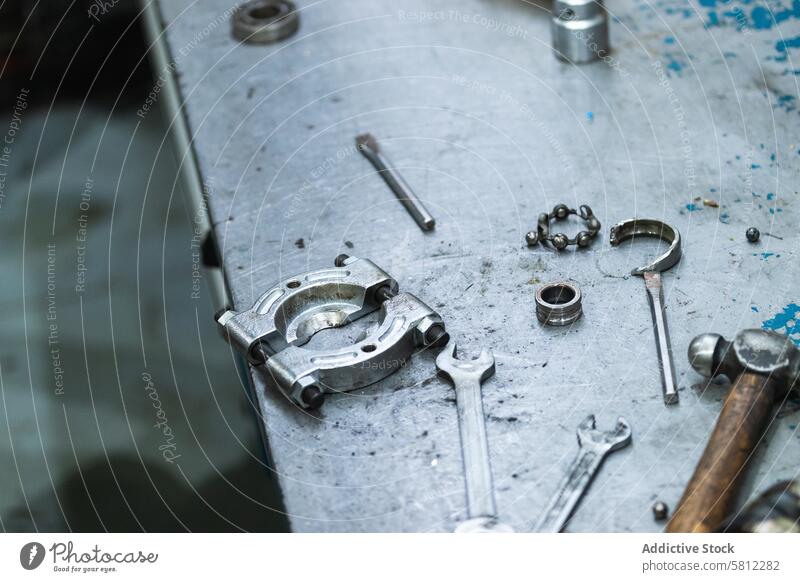 Various repair tools arranged on table in workshop crankshaft bearing remove garage instrument hammer wrench workbench fix manual set equipment spanner