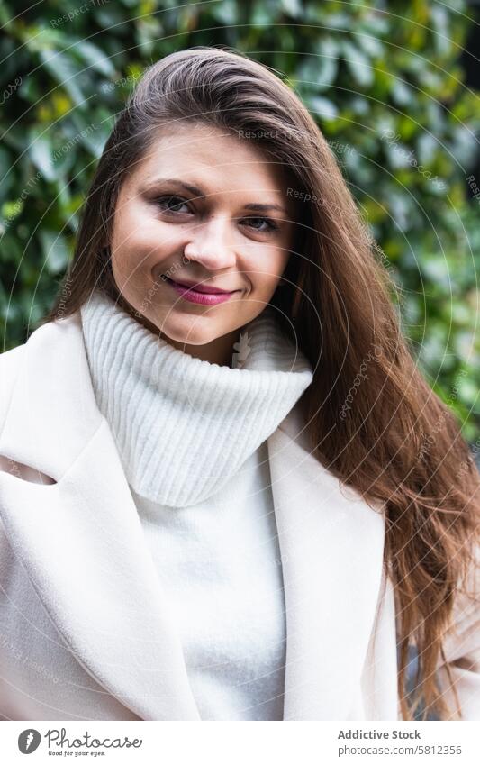 Happy stylish woman with white sweater resting in park style happy smile elegant trendy enjoy fashion charming adult brunette long hair cheerful female