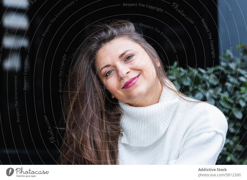 Happy stylish woman with white sweater resting in park style happy smile elegant trendy enjoy fashion charming adult brunette long hair cheerful female