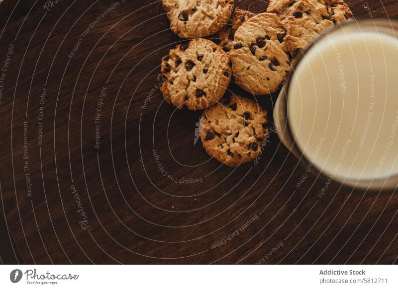 Savoring Simplicity: Homemade Cookies with a Glass of Milk on an Elegant Wooden Table. Comfort Food Classic Treat Delicious Snack Culinary Indulgence