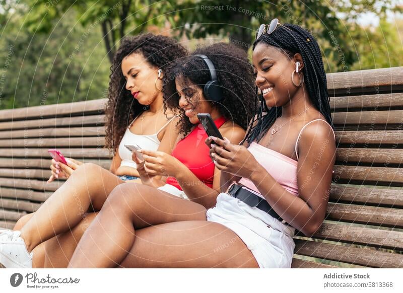 African American Friends Enjoying Summer Together and listening to music Diversity Youth Communication Joy Laughter Happiness Leisure Relaxation Outdoors Fun