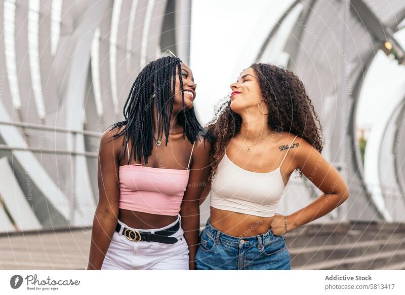 African American female friends enjoying a summer day Summer Friends Diversity Youth Communication Joy Laughter Happiness Leisure Relaxation Outdoors Fun