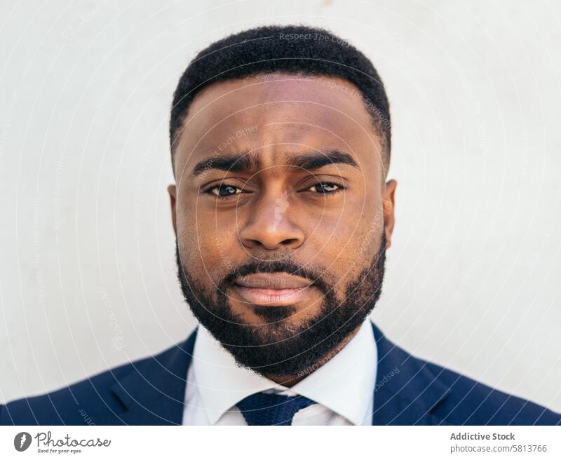Close-up of a confident black businessman looking at camera african american male professional executive success entrepreneur finance corporate productivity