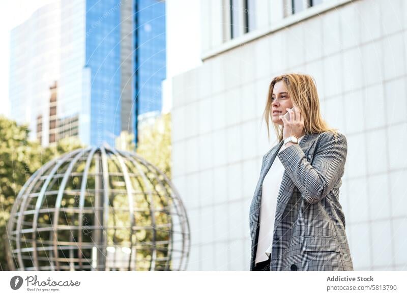 Businesswoman in suit talking on the phone while leaving the office business meeting professional executive success entrepreneur finance businesswoman corporate