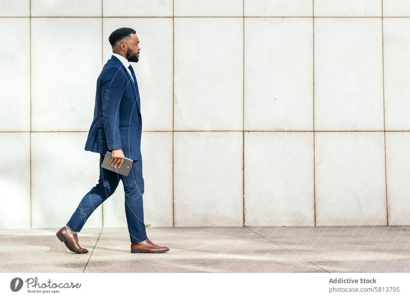Side view of a black businessman in a suit a on her way to the office Businessman Suit Heels Office Professional Career Fashion Commute Success Confidence Power
