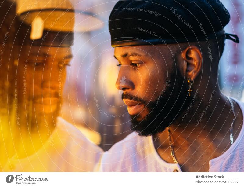 Black man near a glass. reflection and warm light African American Glass Reflection Warm light Indoor Mood Contemplation Serenity Tranquility Relaxation