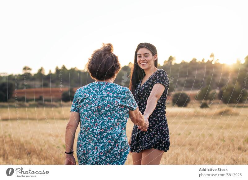 Taking advantage of life Grandmother and granddaughter in a field of sunflowers. woman elderly nature people summer agriculture outdoor yellow senior happy