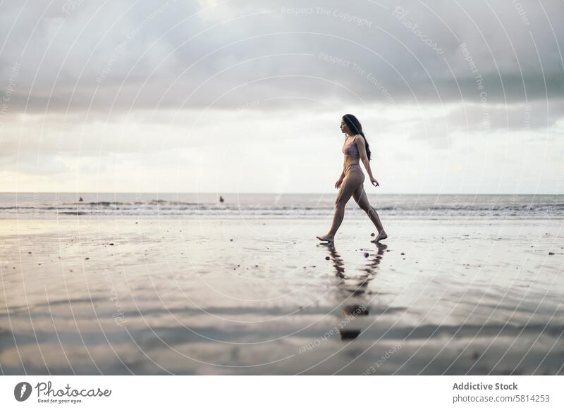 Caucasian woman walking on the beach at sunset young sea summer lifestyle happy travel beautiful ocean nature vacation people sky female happiness outdoor water