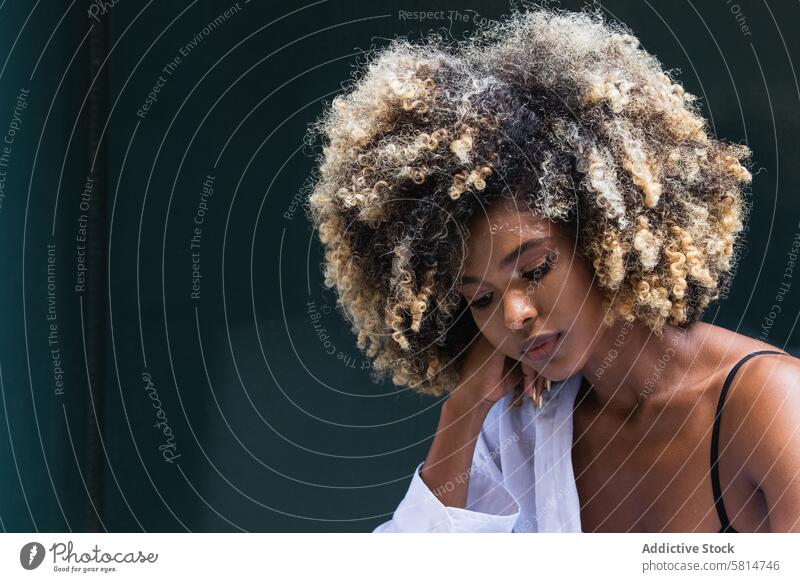 Pensive stylish black woman standing near colorful door style cool millennial serious thoughtful female staircase young afro pensive denim carefree