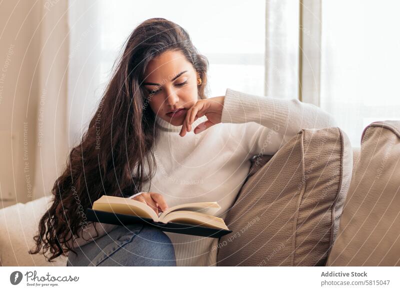 Relaxing at Home: Young Woman Reading a Book Sofa Relaxation Tranquility Comfort Serenity Contentment Leisure Cozy Lifestyle Peaceful Pleasant Enjoyment Indoor