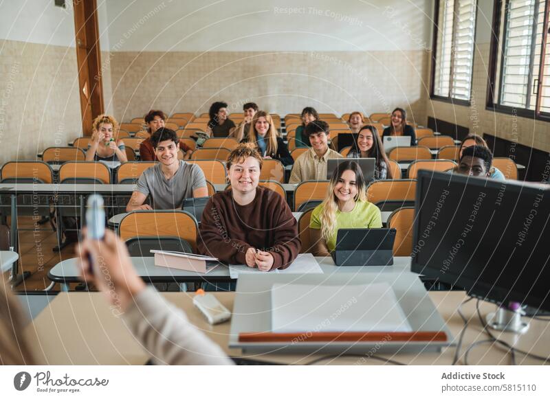 Diverse students listening to teacher lesson university classroom smile lecture education explain lecturer tutor academic group knowledge college teen teenager