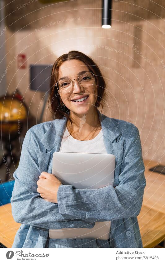 Happy female manager with laptop in workplace businesswoman smile happy smart casual embrace portrait young style cheerful glasses workspace glad pc computer