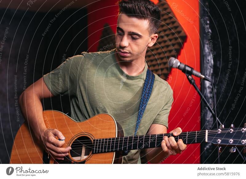 Musician practicing with the guitar in a recording and rehearsal room. Rehearsal Passion Creativity Art Performance Instrument Melody Rhythm Sound Practice