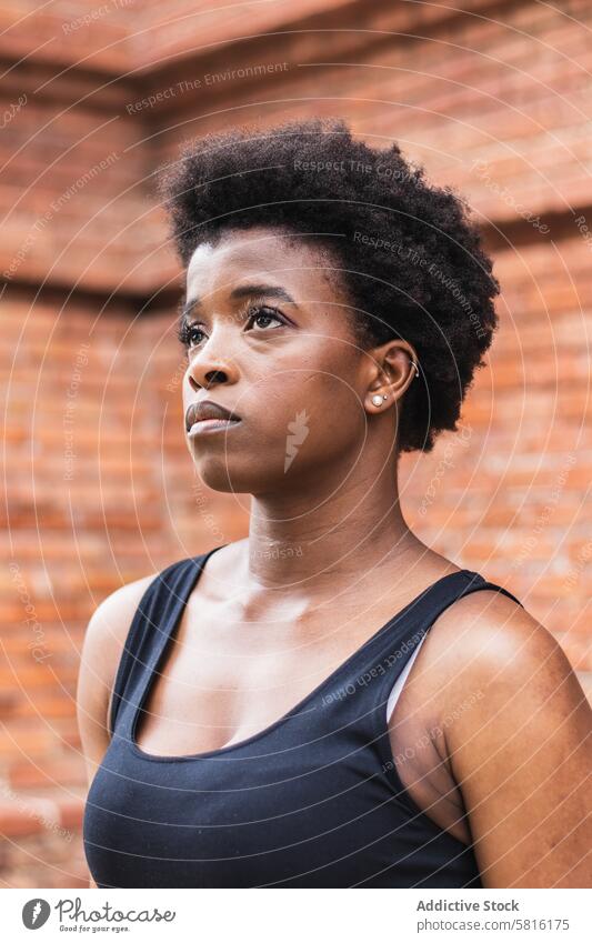 Sad black woman with Afro hairstyle looking away unhappy serious trouble upset lonely think stress tired sad female thoughtful focus gaze mind mood confuse