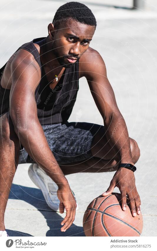 Confident black sportsman on basketball court in summer sports ground player determine city male ethnic african american sportswear style confident recreation