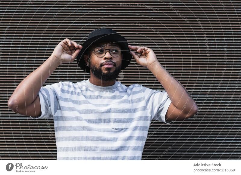 Back hipster man in hat looking away trendy smile beard eyeglasses optimist male african american black ethnic outfit style positive joy lifestyle glad delight