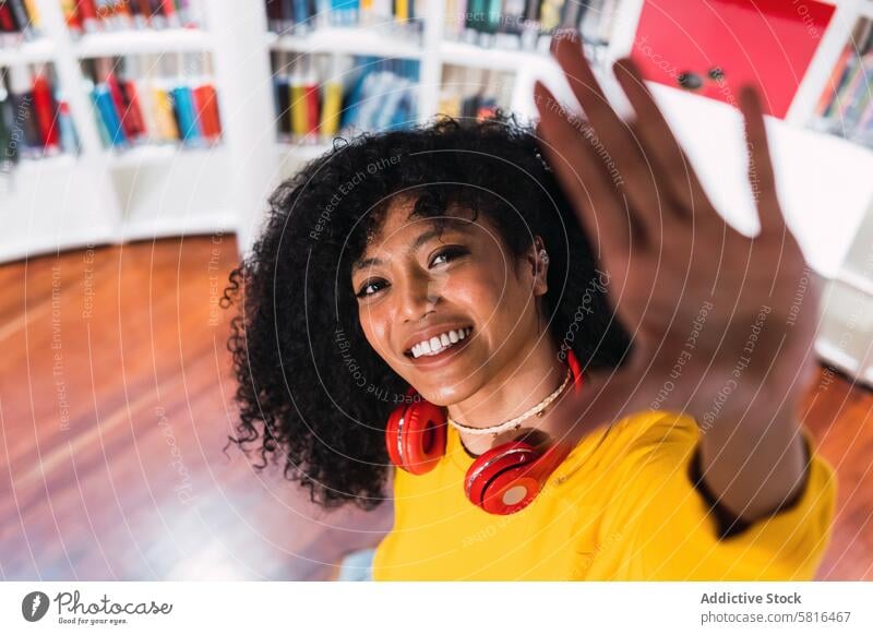 Portrait of cheerful African American woman in headphones melomaniac smile music portrait listen enjoy high angle ethnic happy student african american female