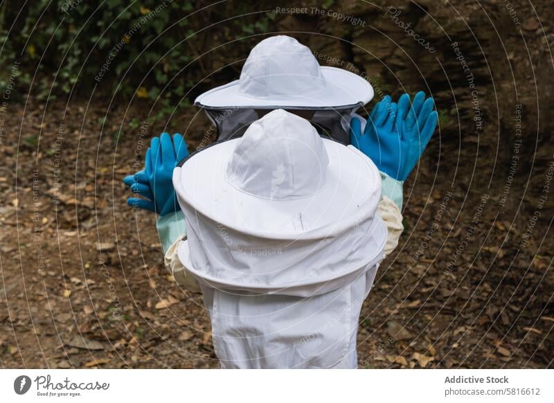 Faceless group of children in protective uniform in apiary costume together kid garden countryside safety glove rubber meadow village gather apiculture nature