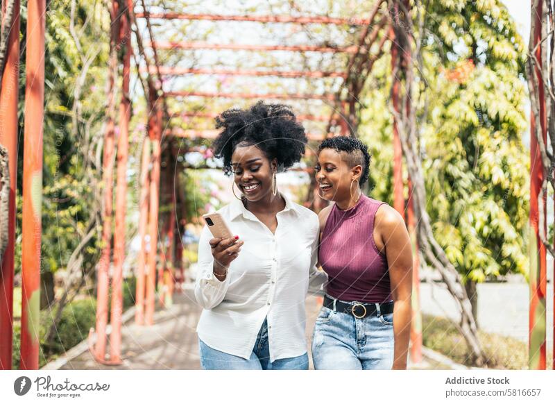 Happy women taking selfies with smartphone walking in the park happy young summer woman female outdoors people leisure lifestyle joyful looking spring enjoyment