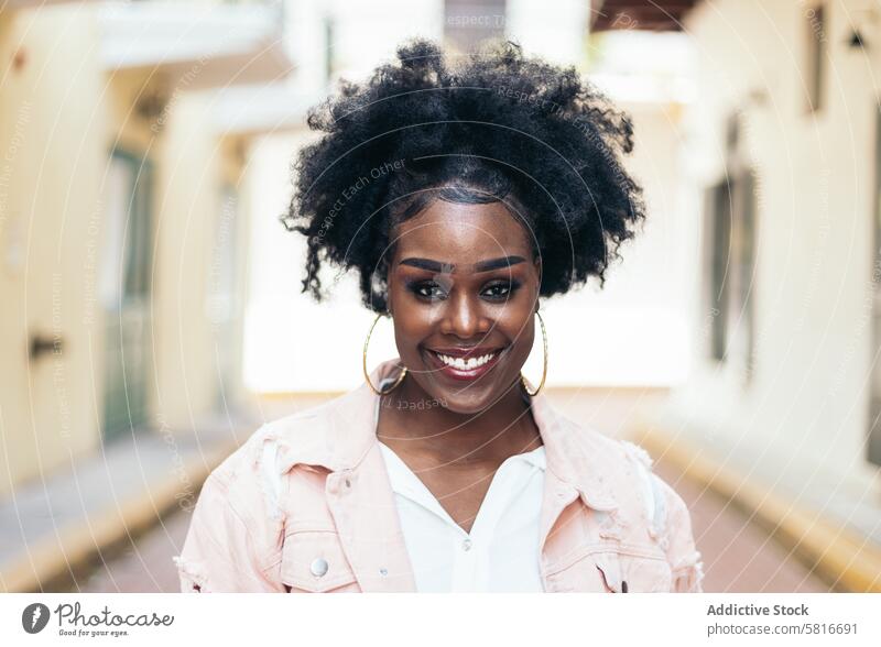 Portrait of a pretty black woman with afro hair street city young female outdoors urban fashion beautiful lifestyle casual people attractive curly portrait