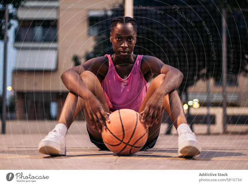 Confident female basketball player on the court basketball game outdoor sports active lifestyle youth culture leisure activity sporting event exercise