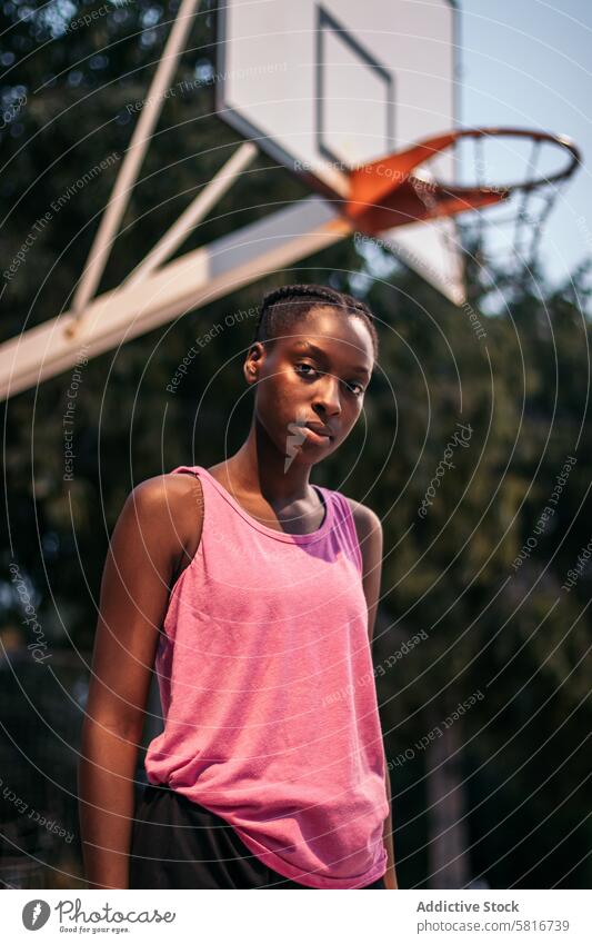 Confident female basketball player on the court sport young game lifestyle urban outdoor athletic active basketball game active lifestyle youth culture