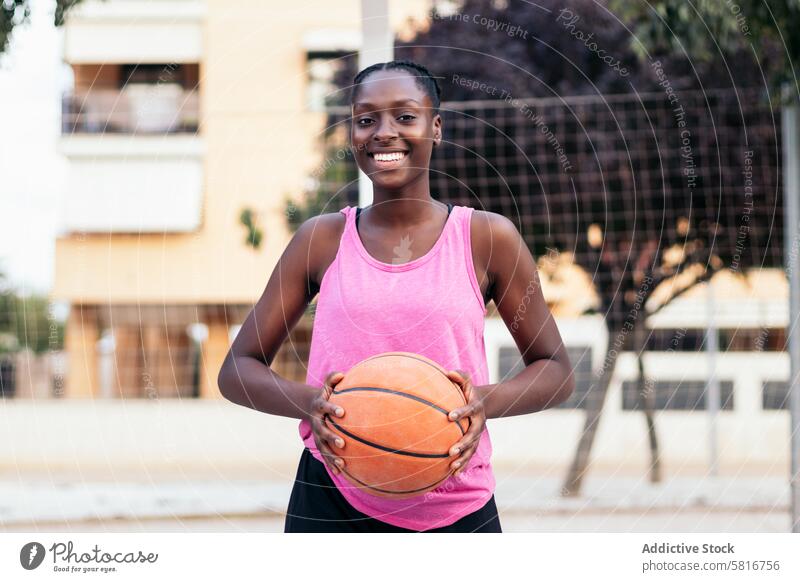 Portrait of Female Basketball Player Holding Ball basketball sport young game court lifestyle player urban outdoor athletic active playing leisure sportsmanship