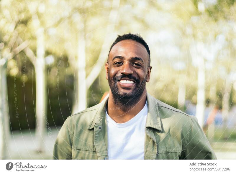 young black man portrait in a park. lifestyle people male african guy casual outdoor person adult happy outside handsome one looking american attractive
