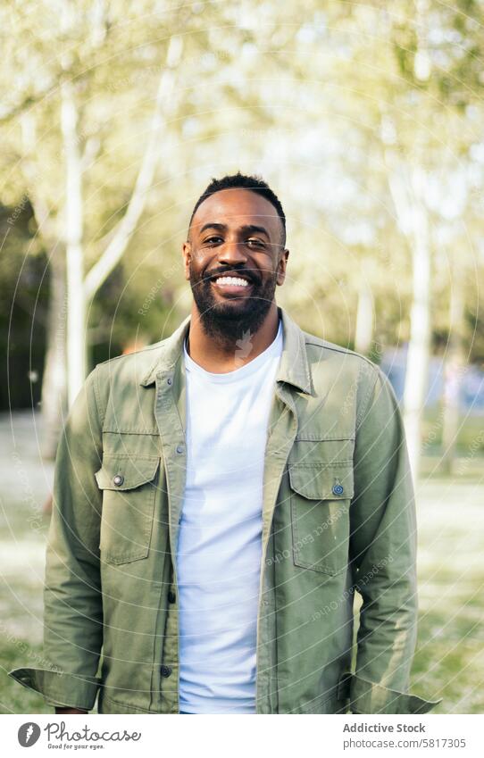 young black man portrait in a park lifestyle people male african guy casual outdoor person adult happy outside handsome one looking american attractive outdoors