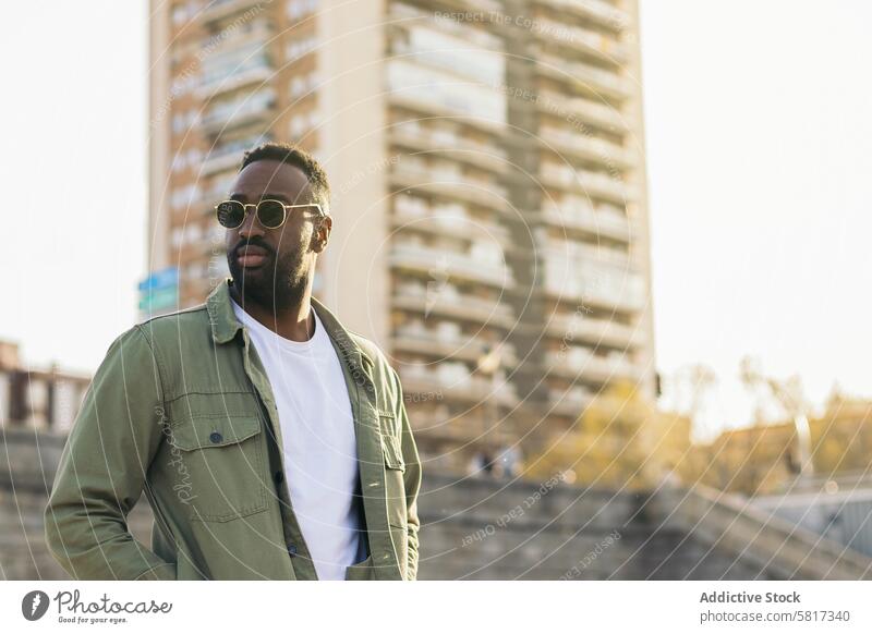 handsome and attractive afro american man with sunglasses. reflects of sunlight african guy young male black person happy casual adult stylish fashion portrait