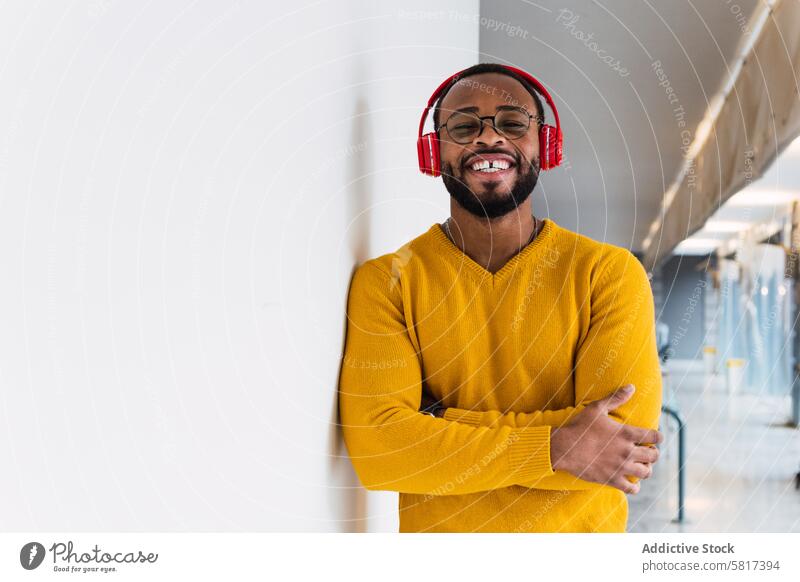 Black man listening to music in headphones smile using relax rest chill song delight meloman male happy black glad african american enjoy teeth gap device