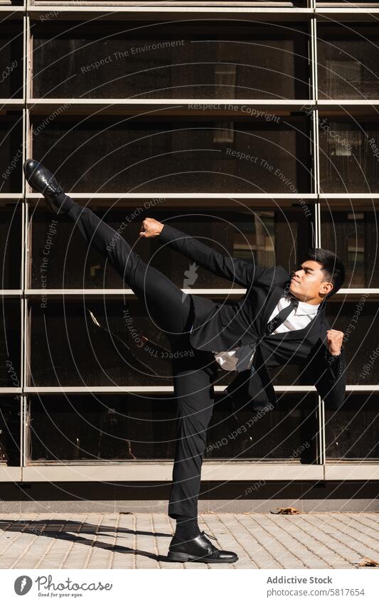 Businessman performing kick in air in street businessman kickboxing confident scream fight angry rebel yell power suit male asian ethnic formal entrepreneur