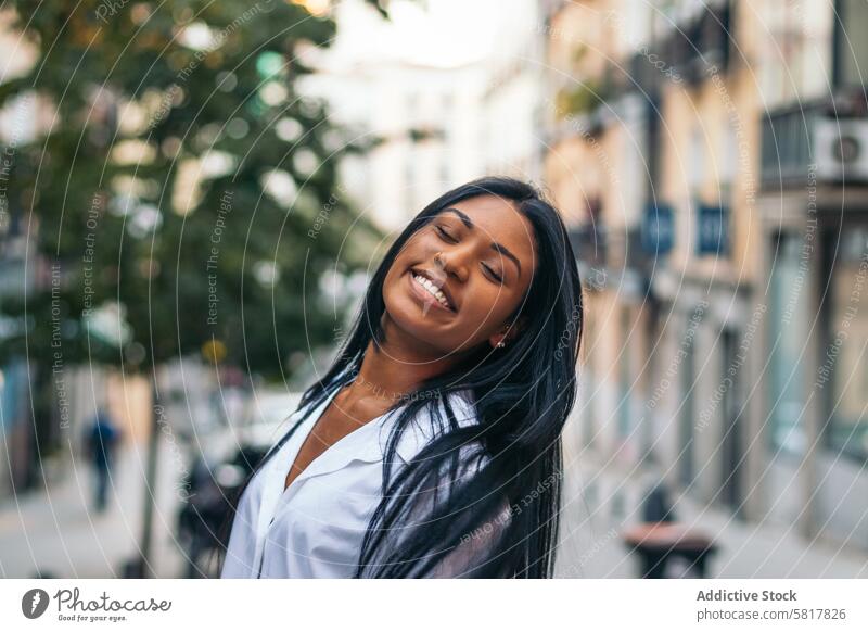 Portrait of a smiling latin american woman outdoors people lifestyle happiness casual cheerful leisure street europe portrait standing happy person smile
