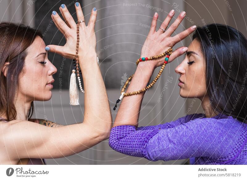 Young Hispanic women meditating with closed eyes during yoga training meditate eyes closed prayer zen jamala balance calm together peaceful spirit asana harmony