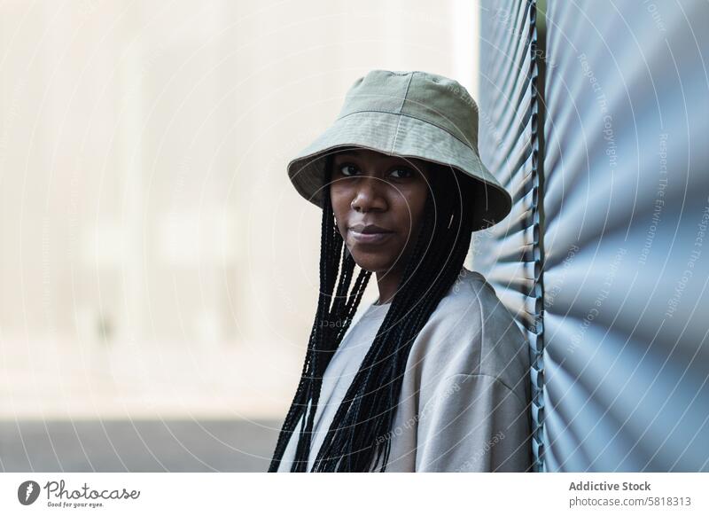 Young black woman in hat style casual appearance urban modern summer outfit young portrait braid female african american ethnic model hipster individuality