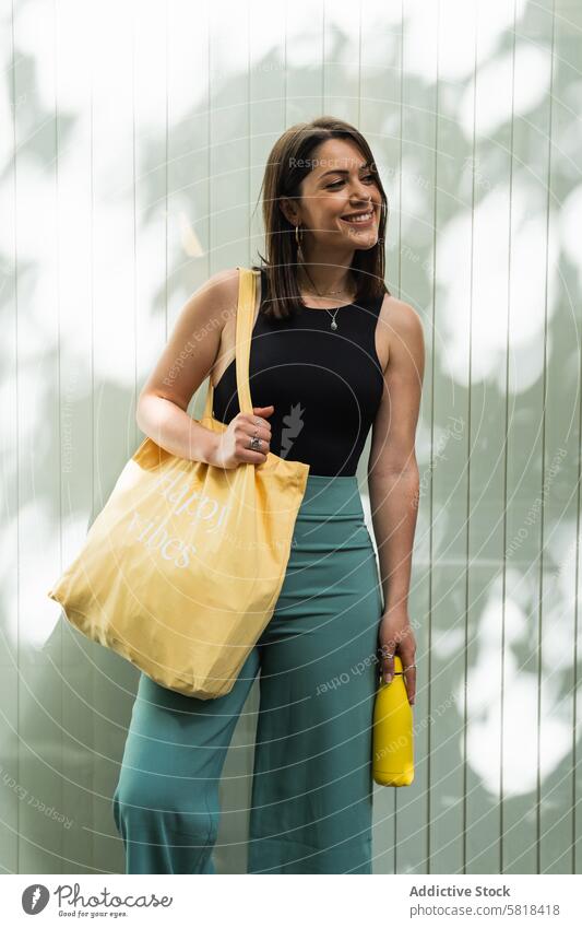 Happy woman with eco friendly bag in city shopping bag reuse zero waste street ecology reduce female sustainable natural textile fabric satisfied customer urban