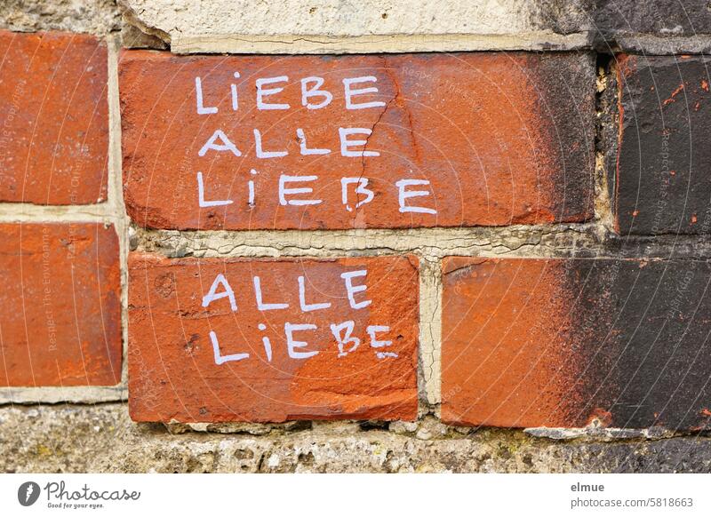 LIEBE ALLE is written several times on a red brick wall Dear All Love all love Daub Youth culture embassy Street art Mural painting Creativity Art Lifestyle