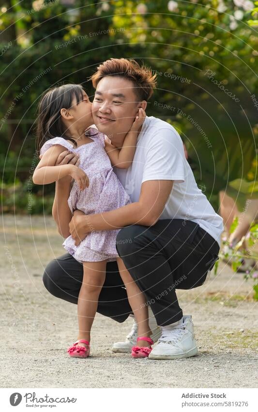 Asian father and daughter sharing a moment on vacation asian europe family love embrace happiness travel bonding parent child outdoor summer affection joy