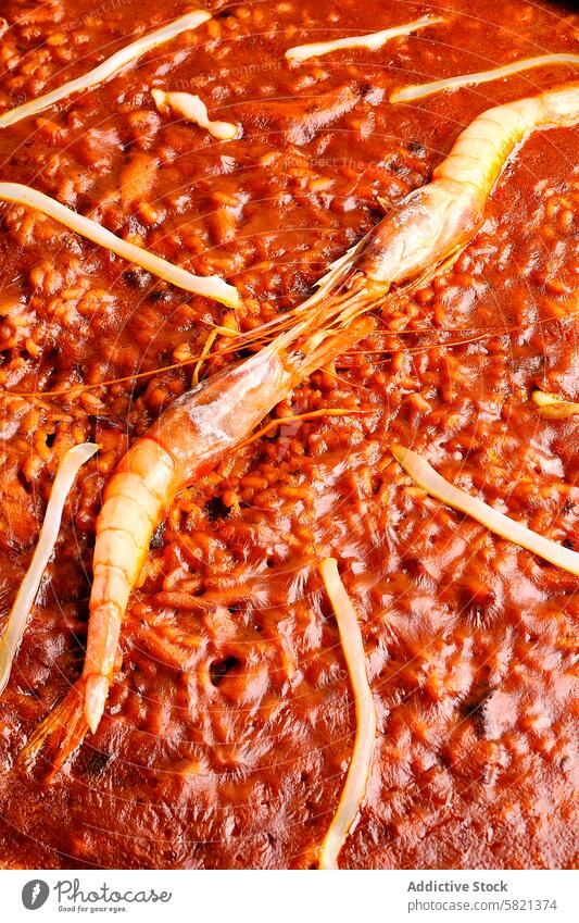 Traditional seafood paella with whole prawn in close-up rice traditional spanish cuisine savory dish meal texture tomato saffron crustacean gourmet delicious