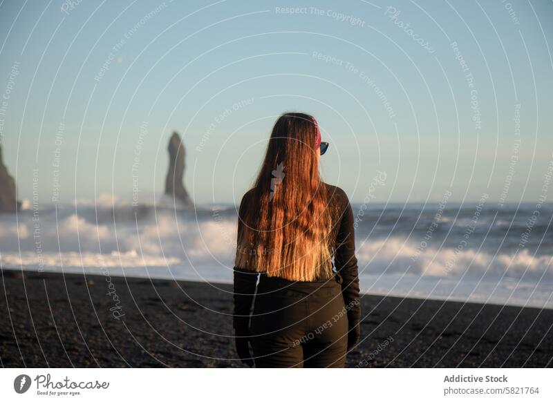 Woman overlooking sea stacks on Iceland black sand beach iceland woman ocean wave coast serene morning nature travel solitude scenic landscape coastline outdoor