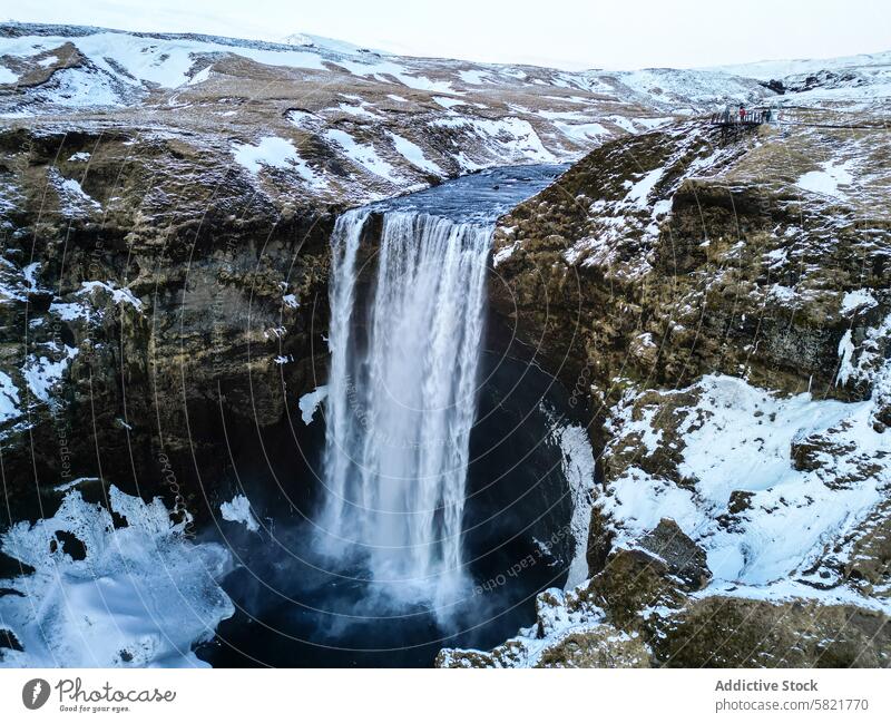 Majestic waterfall in a snowy Icelandic landscape iceland canyon nature outdoor winter cascade scenic visit travel cliff cold majestic natural beauty tourist