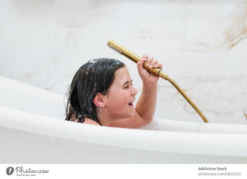 Girl enjoying a playful moment during bath time girl smiling eyes closed shower happiness childhood fun water showerhead personal care hygiene bathroom