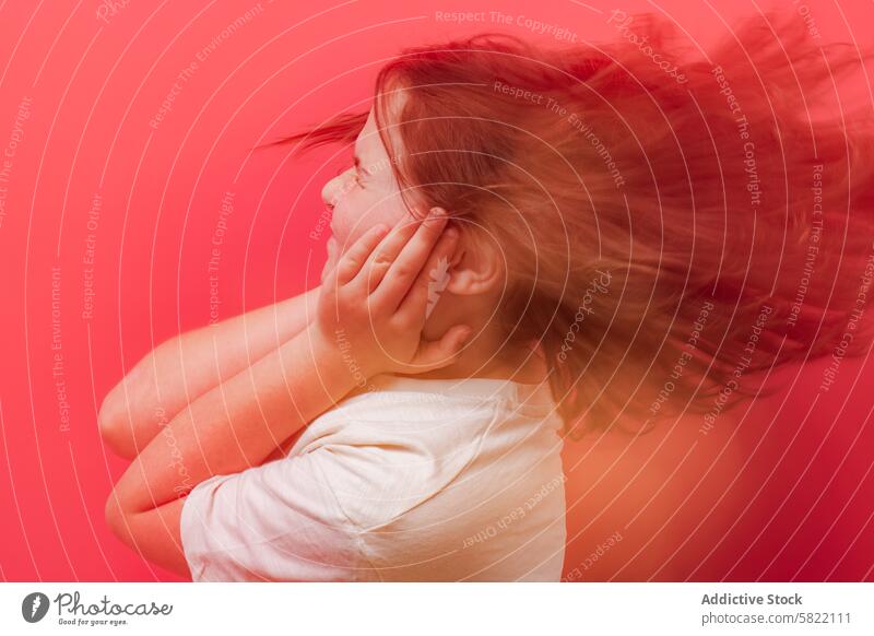 Young child feeling dizziness with hands on head against red background hypoglycemia symptom disorientation health issue girl discomfort medical healthcare