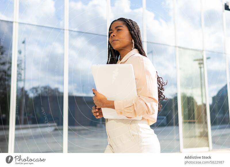 Businesswoman with laptop outside modern building businesswoman office building professional confident ambition success glass contemporary outdoor career work