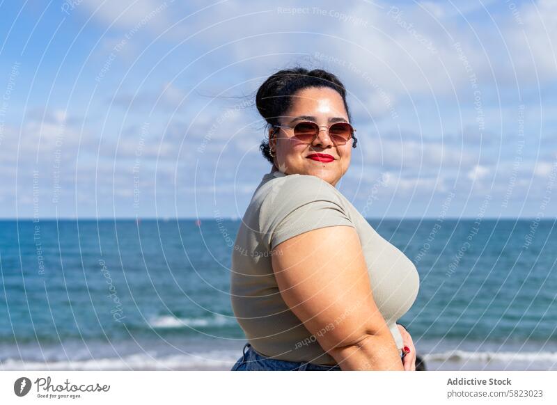 Smiling Woman Enjoying Summer Day in Barcelona woman summer barcelona sea sunglasses smiling confidence sunny contentment beach coast leisure african american